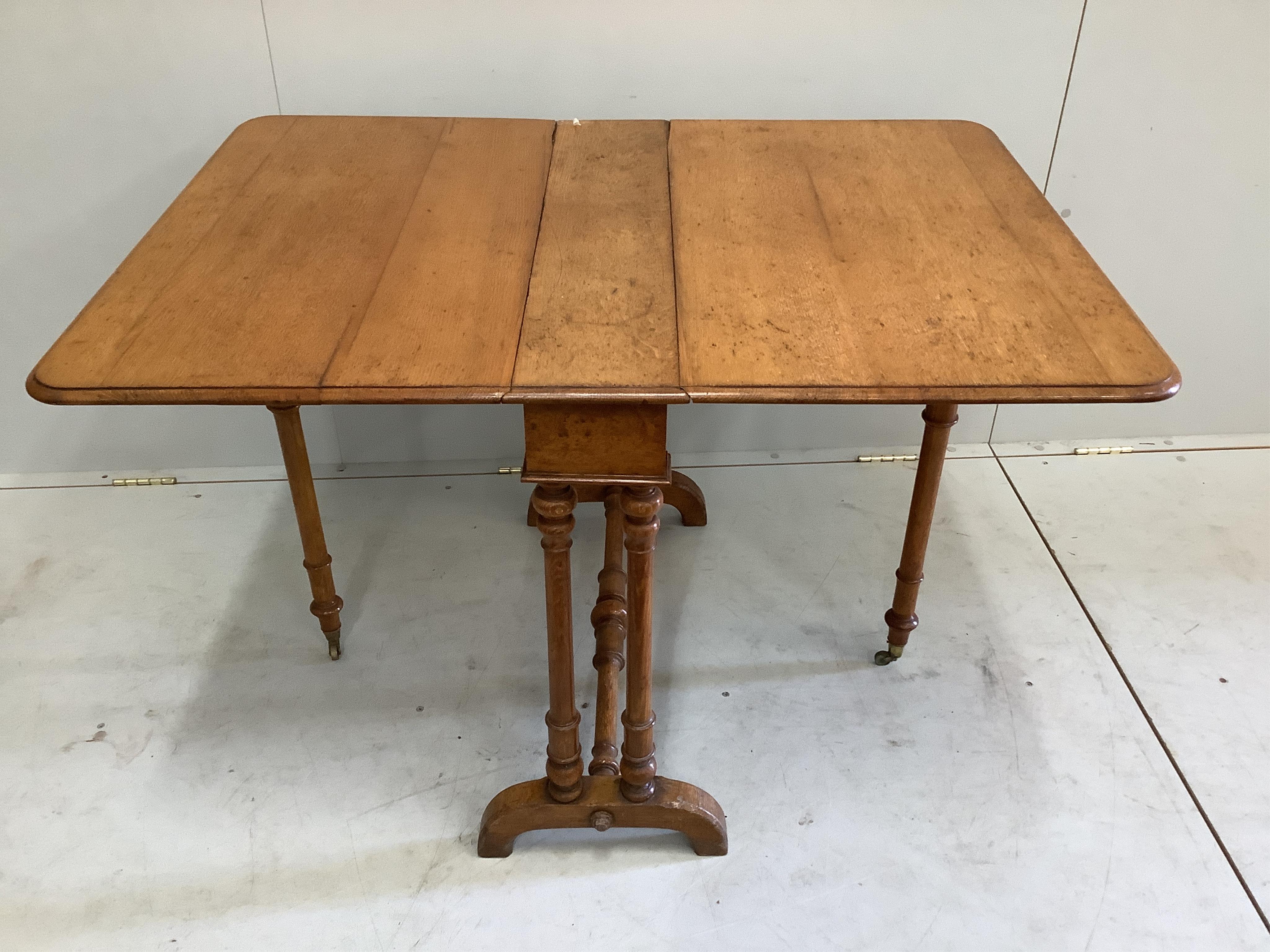 A late Victorian Howard and Sons oak Sutherland table, width 76cm, depth 18cm, height 68cm. Condition - fair